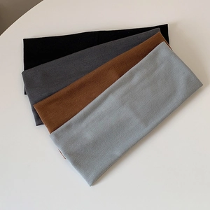 Set of four elastic non-slip sports headbands in black, grey, and brown knit fabric