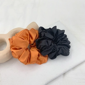 Elegant satin scrunchie set in orange and black silk finish for stylish ponytails