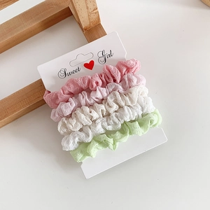 Set of four pastel fabric scrunchies in pink white and green for high ponytail styling