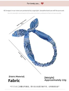 Detailed view of blue paisley print headband showing dimensions 26cm by 18cm with weight