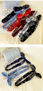Detail of paisley print knotted headbands with elastic bands in multiple colors
