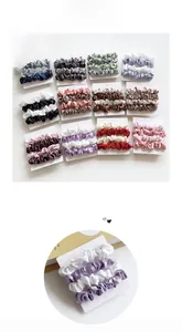 Detail of silk satin scrunchie set in various colors on cards for ponytail styling