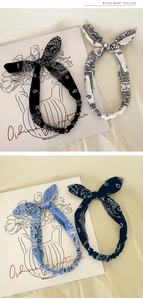 Detail view of four-color paisley knot headbands with elastic back and bunny ear style