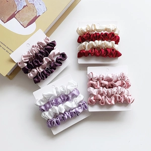 Set of 4 elegant satin scrunchies in vintage red, champagne gold, and lavender purple
