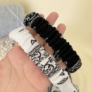 Knotted paisley print and solid black elastic headbands set with pleated texture fabric