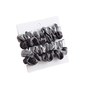 Set of three satin silk scrunchies in gradient shades of grey on a white card display