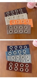 Detail showing various colors of punk style ribbed headbands with metal eyelet rings