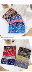 Detail of printed fabric headbands with paisley patterns and silver metal eyelets