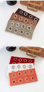 Close-up of punk style elastic headbands with metallic eyelets in six assorted colors