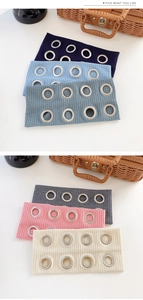 Close-up of ribbed knit headbands with metal eyelets in assorted colors and textures