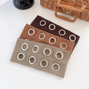 Three punk style elastic wide headbands with metal eyelets in brown, tan, and grey