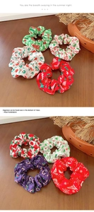 Weihnachts-Haargummis mit festlichen Mustern auf einem rustikalen Holzhintergrund