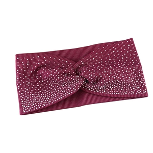 Sparkly burgundy knitted headband with rhinestone embellishments and a stylish twist knot