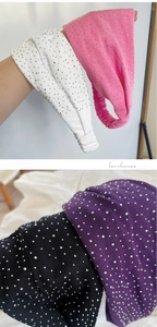 Detail view of elastic wide headbands with shiny rhinestones in four soft colors