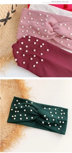 Detail view of pearl-embellished knitted criss-cross headbands in multiple colors