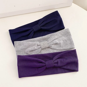 Three-piece set of solid color elastic yoga headbands in dark blue, grey and purple