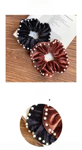 Detail view of velvet scrunchies with white pearls in black and coffee brown colors