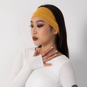 Elastic mustard yellow knit sports headband for yoga and fitness worn by model