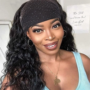 Elastic black wide headband with rhinestones worn by a model in a cozy indoor setting