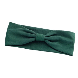 Solid dark green elastic yoga headband for women with stylish front knot detail