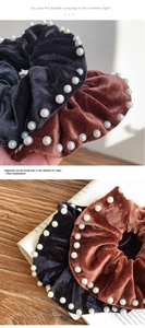 Close-up detail of vintage velvet scrunchies with white pearls in black and brown colors