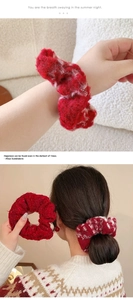 Detail of red and white plush scrunchie shown as wrist accessory and hair tie styling