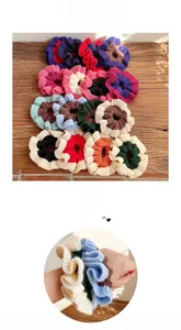 Macro detail of multi-colored ruffled knit hair scrunchies with soft woolen texture