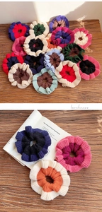Close-up of handmade two-tone knitted scrunchies with soft woolen texture on wood