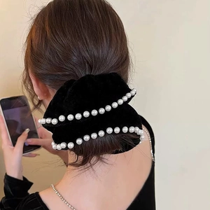 Elegant vintage black velvet scrunchie with faux pearls on long brown hair back view