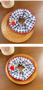 Close-up of blue plaid hair scrunchie with red button and cherry pattern detail