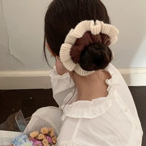 Handmade two-tone knit scrunchie in coffee and cream white for autumn hairstyles