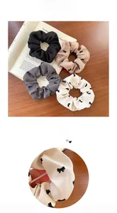 Detail set of four velvet bow scrunchies in black, khaki, grey and white floral prints