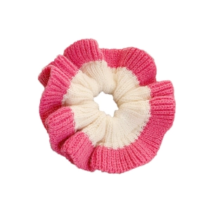 Pink and white handmade knit scrunchie with vertical ribbed texture for messy bun styles