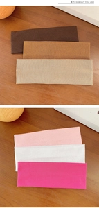 Detail of ribbed knit texture on elastic headbands in coffee, khaki, and cream tones