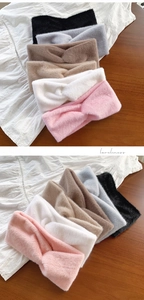 Detailed view of plush cross twist headbands in various colors for autumn and winter