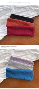 Detail of ribbed knit elastic headbands in various colors on a warm wooden background