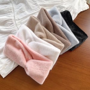Winter faux fur wide twisted headbands in six pastel colors on wood and white fabric