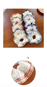 Detail view of lace scrunchies with plaid edges and floral patterns on wooden table