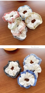 Detailed close-up of lace-trimmed plaid scrunchies in various colorful floral patterns