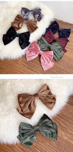 Detail of multi-color velvet bow hair clips with soft 3D double-layered fabric texture