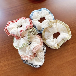Set of 5 plaid lace scrunchies in red, blue, green, yellow and black on wooden surface