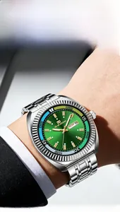 Detailed shot of man wearing a luxury business watch with green dial and steel strap
