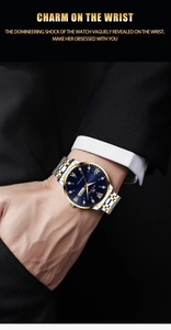 Detail view of a luxury blue dial watch with gold and silver strap worn with a black suit