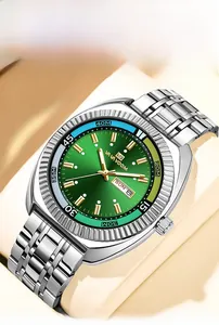 Detail of green dial business watch with luminous gold markers and day-date display
