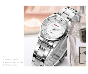 Elegant silver quartz watch with white dial and rhinestone markers on metallic props