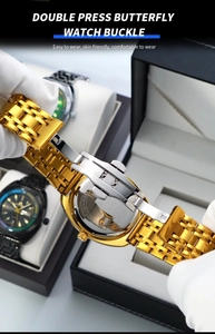 Detailed close-up of golden stainless steel strap with a secure butterfly buckle mechanism