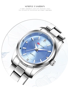 Close-up of light blue sunray dial with rhinestone markers and silver steel strap