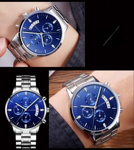 Detailed macro view of the chronograph dials and calendar window on a silver steel watch