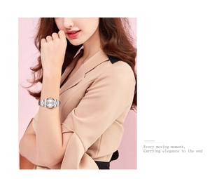 Elegant silver stainless steel watch shown on a female model with a minimalist round dial