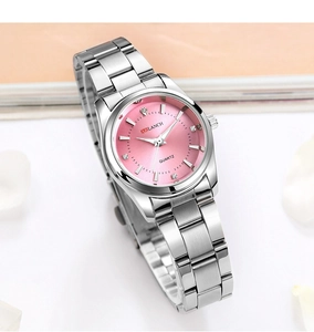 Detail of pink sunray dial ladies watch with rhinestone markers and silver steel strap